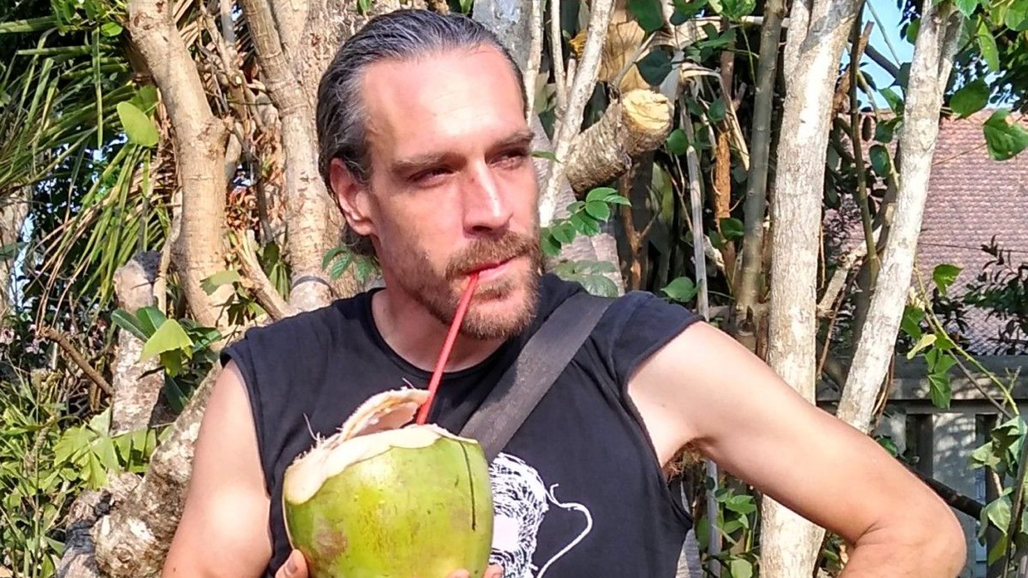 Marc Dusseiller with tropical drink among plants