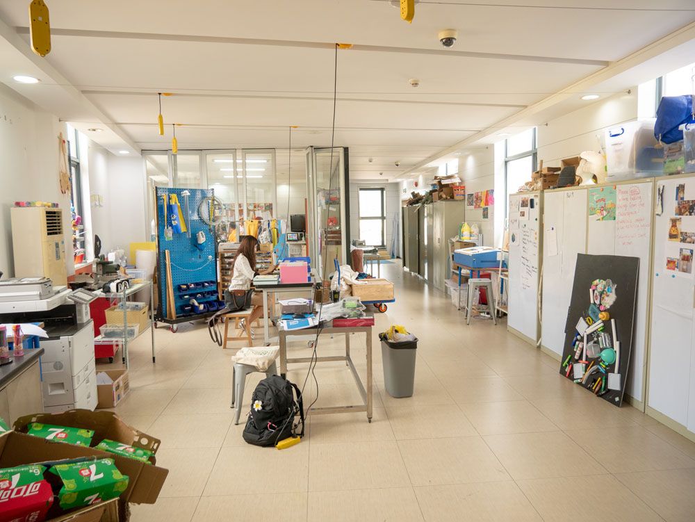 Makerspace workshop room with worktables and whiteboards