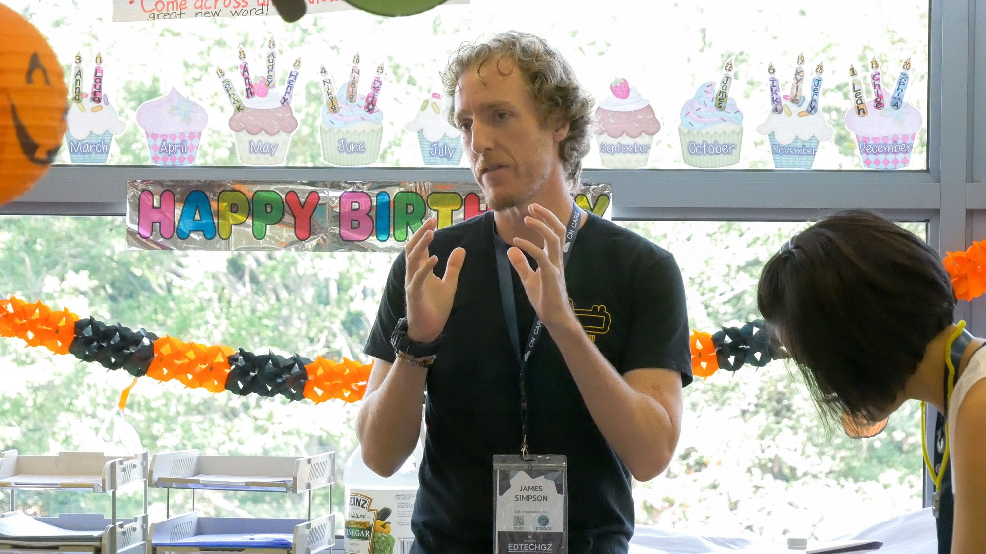Presenter explaining a concept in a classroom decorated for birthdays