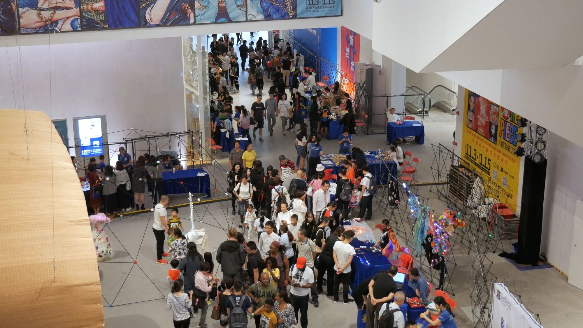 Aerial view of crowds browsing maker faire exhibit tables