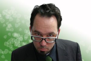 Torrey Nommesen in a close-up portrait against a green gradient background
