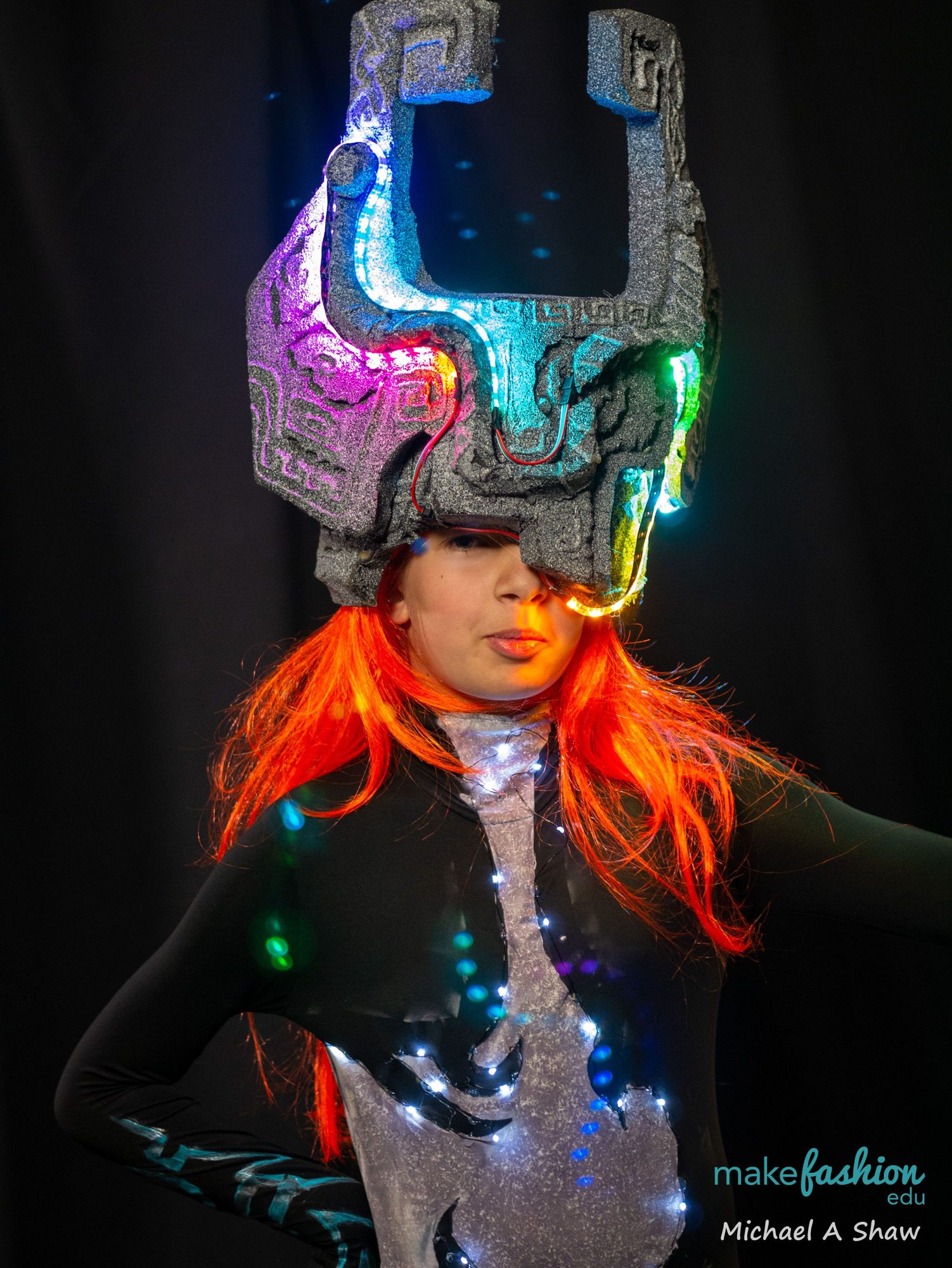 A student wearing a glowing mechanical LED helmet