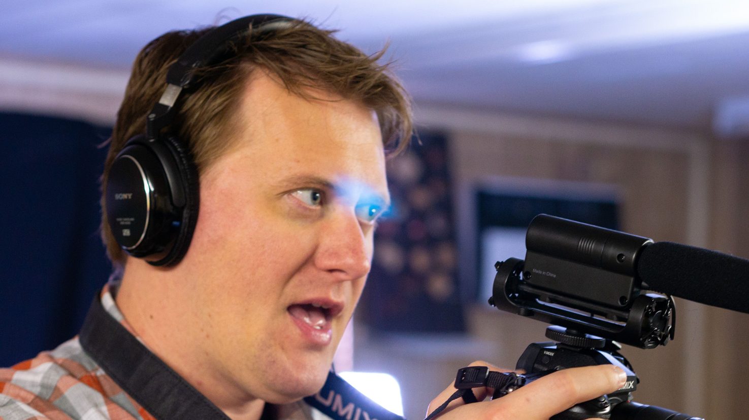 Mike Shaw recording with camera and headphones