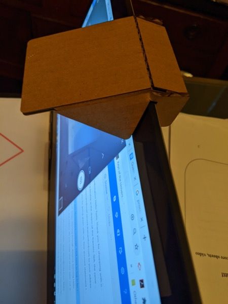 Cardboard reflector clipped to the top of a laptop screen
