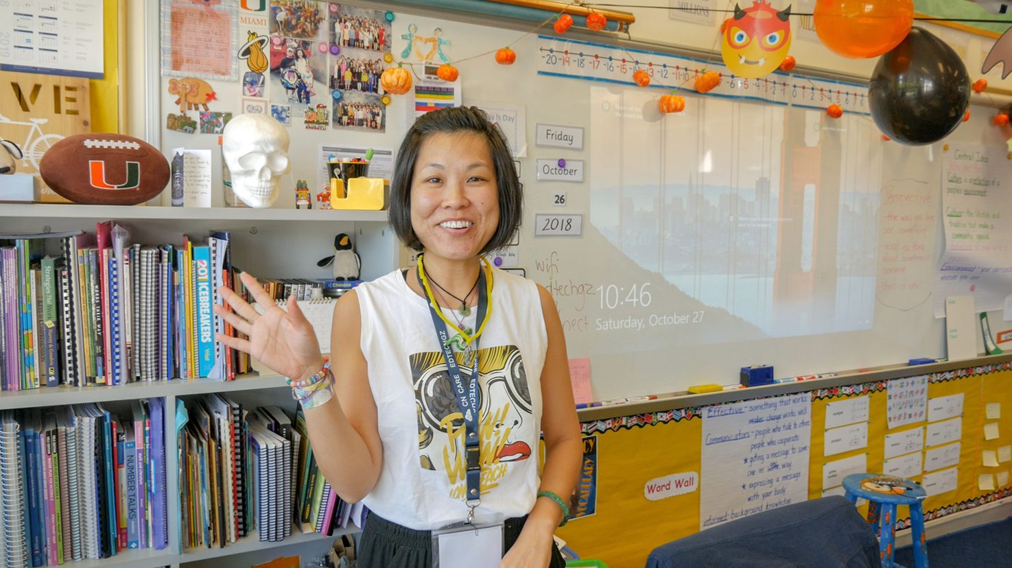 Carrie Leung in a classroom with bookshelves