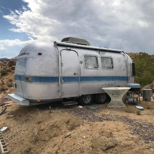 Mobile Makerspace chapter 1: vintage silver Airstream trailer parked in a desert campsite