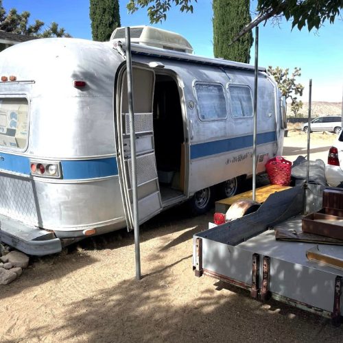 Mobile Makerspace chapter 2: the Airstream with its door open, parked in a shaded driveway