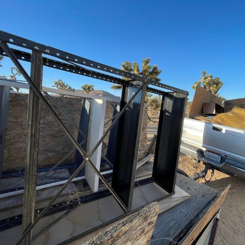 Mobile Makerspace chapter 5: the trailer's bare steel frame set on a flatbed truck in the desert
