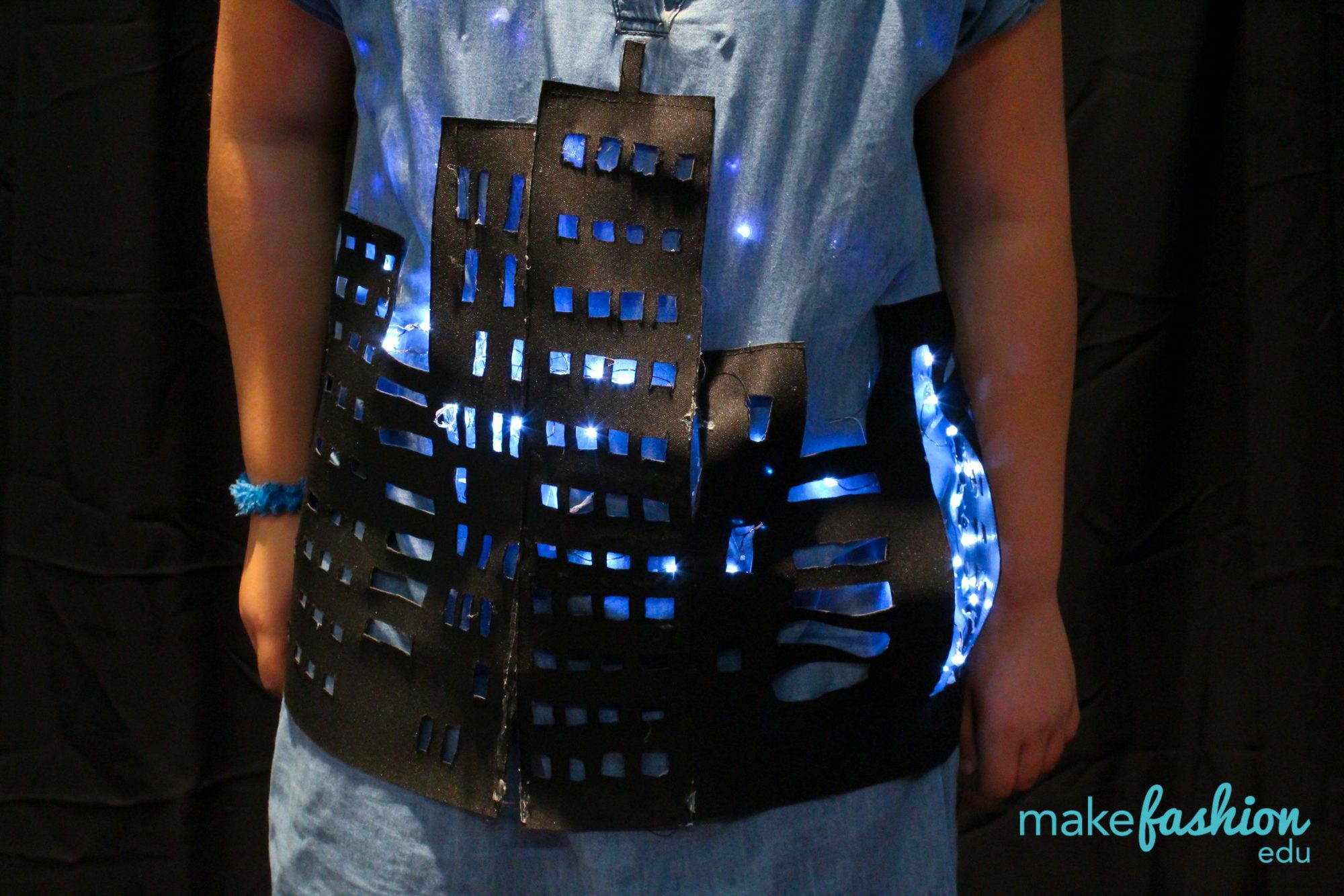 Cityscape bodice with skyscraper windows cut out and lit blue