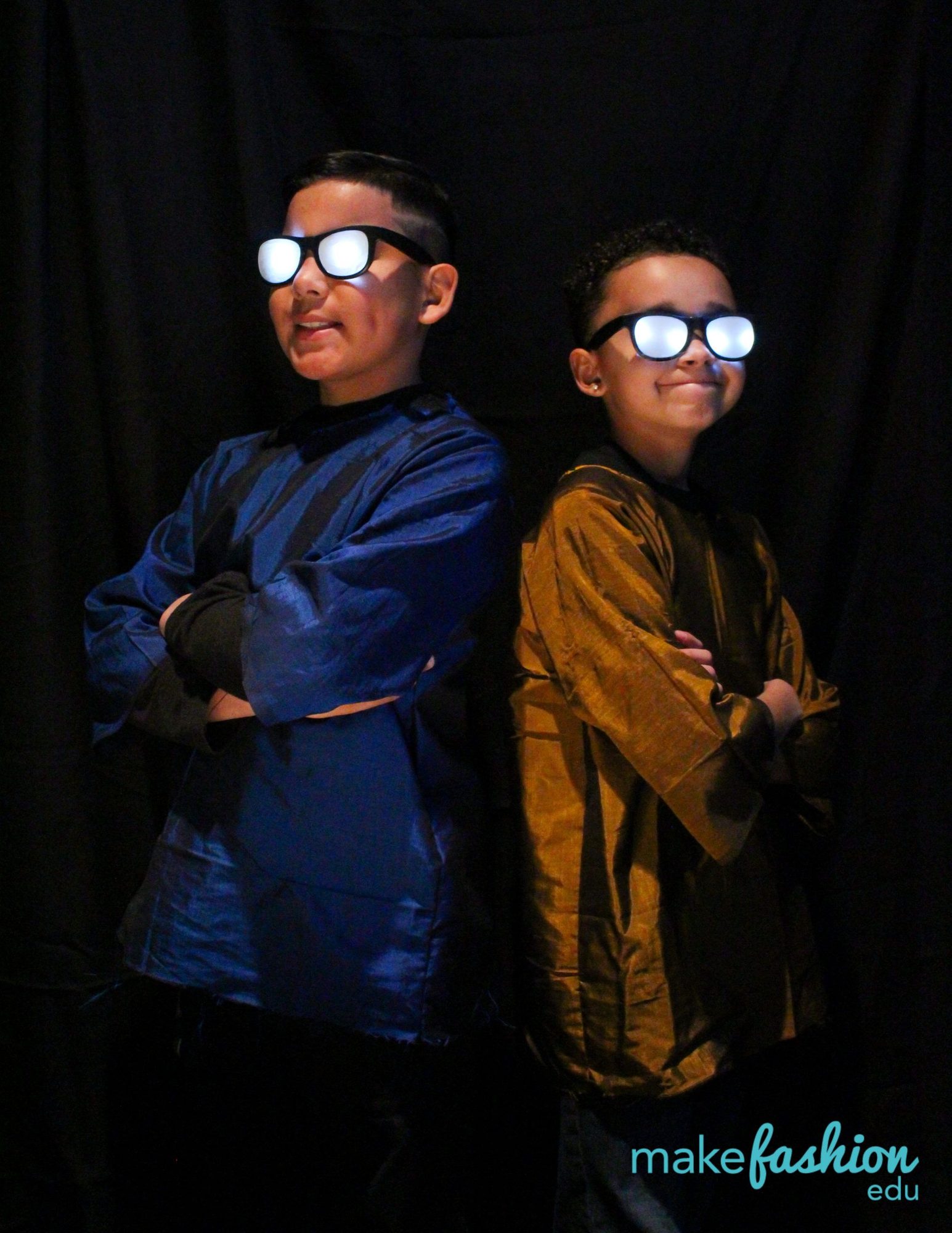Two student models in silk jackets wearing LED light-up glasses