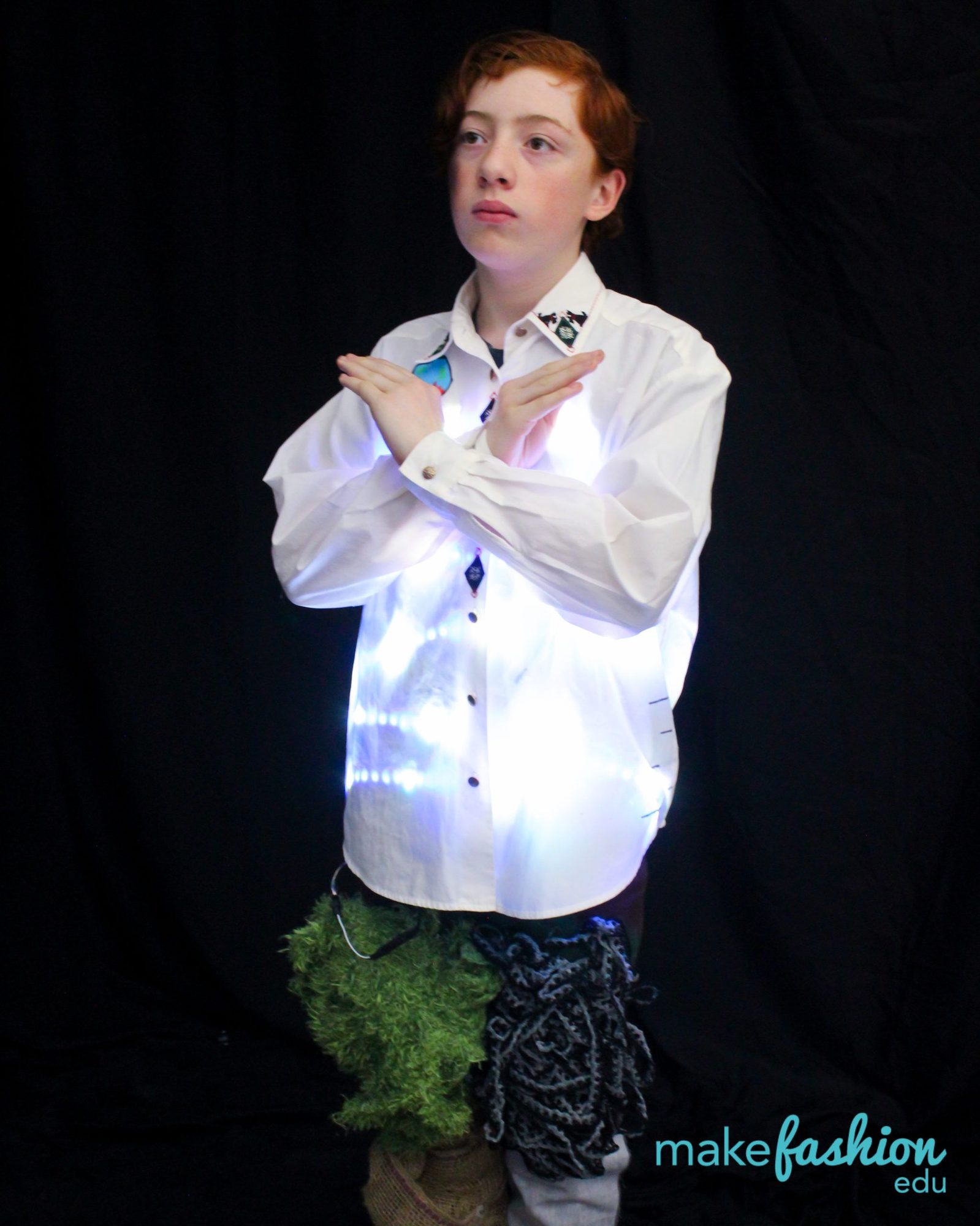 Student in a white dress shirt lit from within with blue LEDs