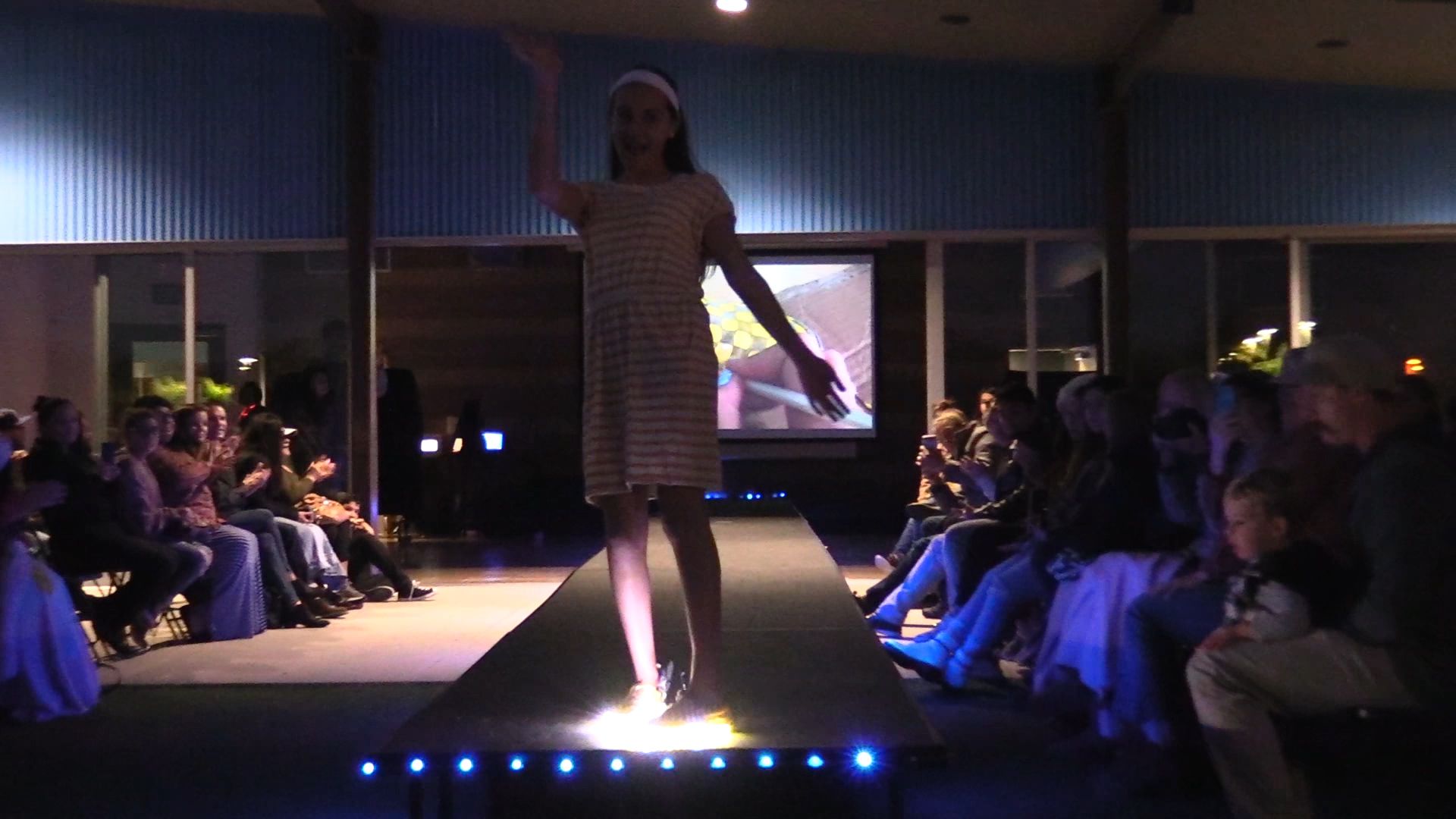 Student on runway in striped garment with glowing LED feet
