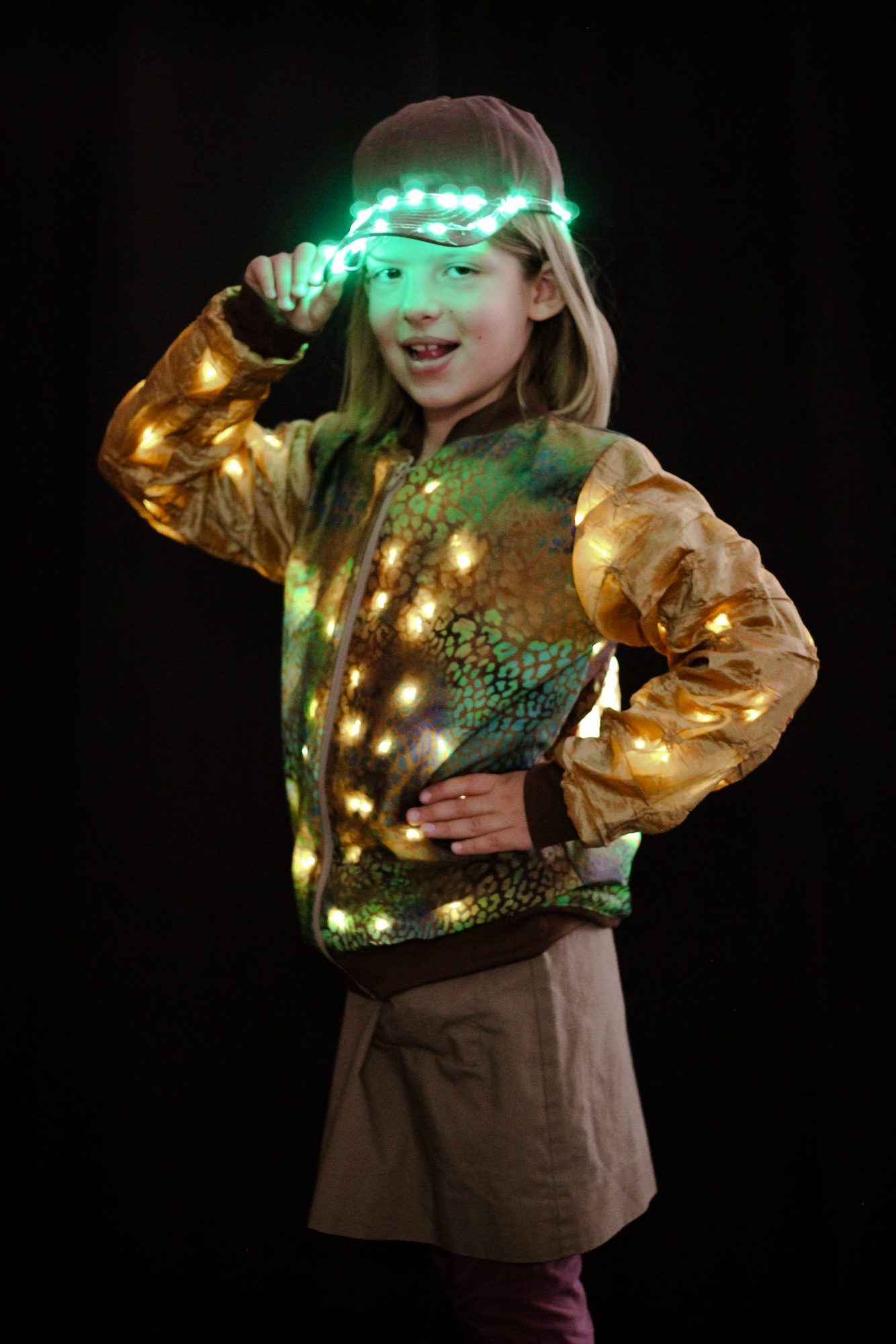 Student in scaled jacket with warm LED lights and glowing green headband