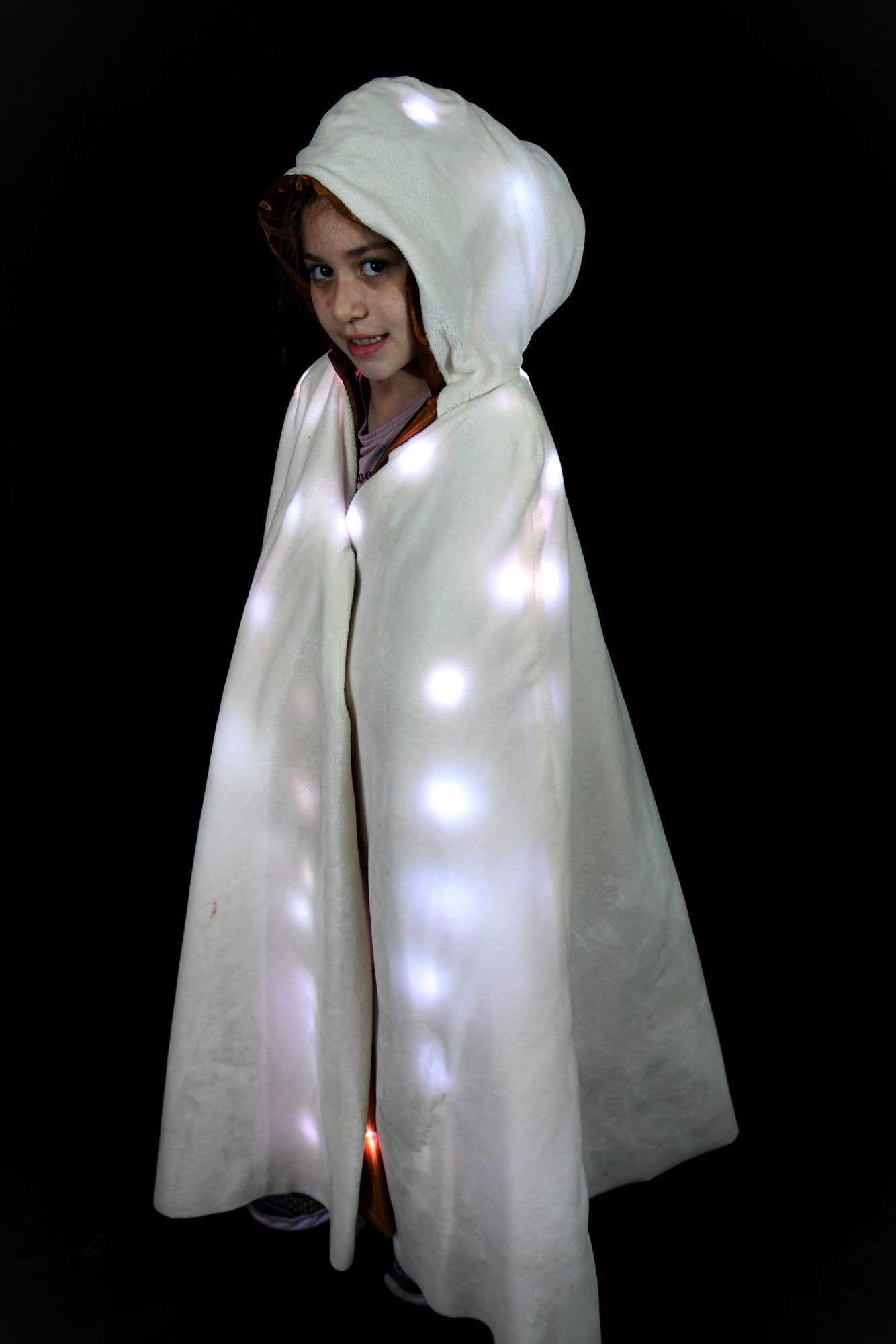 Student in white hooded cloak with scattered LED lights