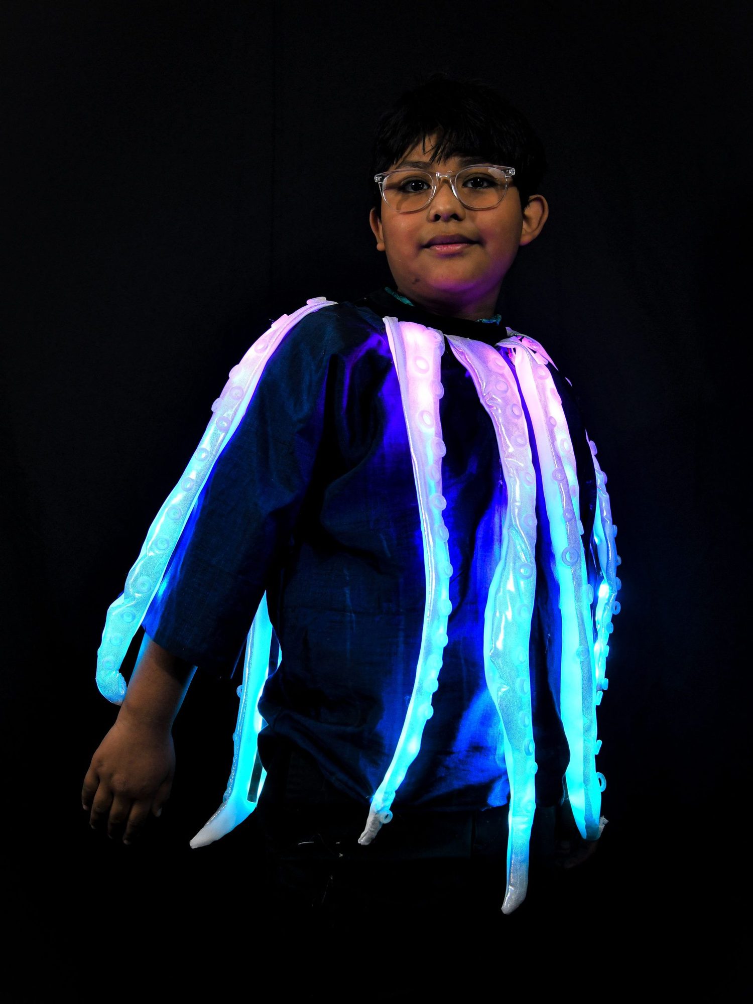 Student wearing octopus costume with glowing blue and pink LED tentacles