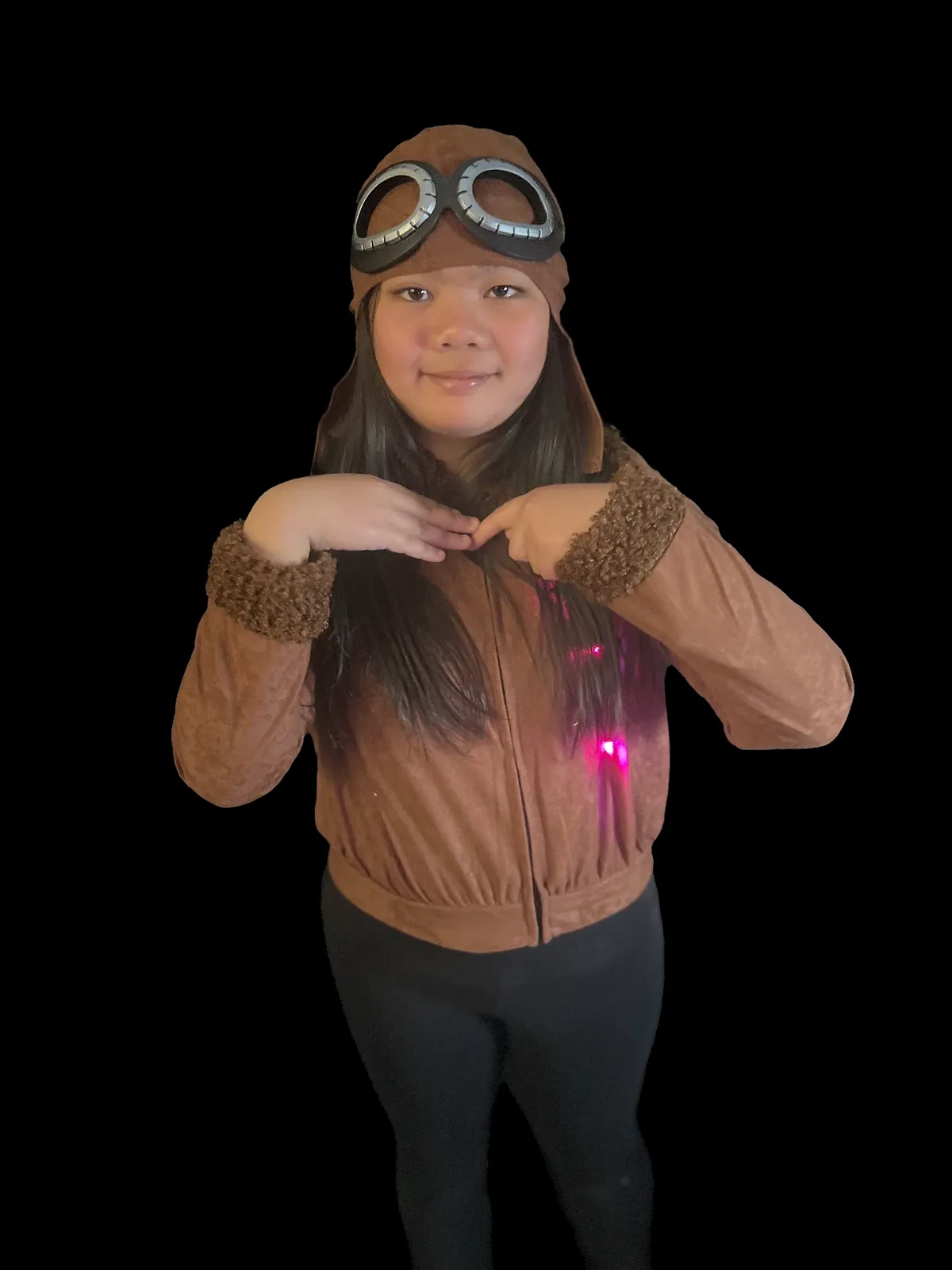 Student as Bessie Coleman in a brown aviator jacket with fleece cuffs and a flying cap with goggles, hands at the collar