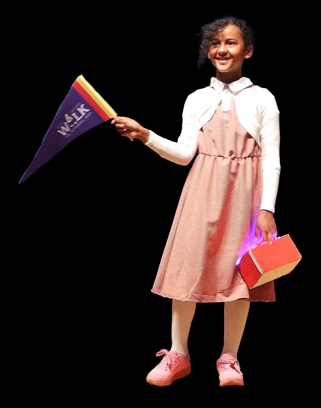 Student as Ruby Bridges in a pink dress and white cardigan, waving a pennant and carrying a glowing red lunchbox