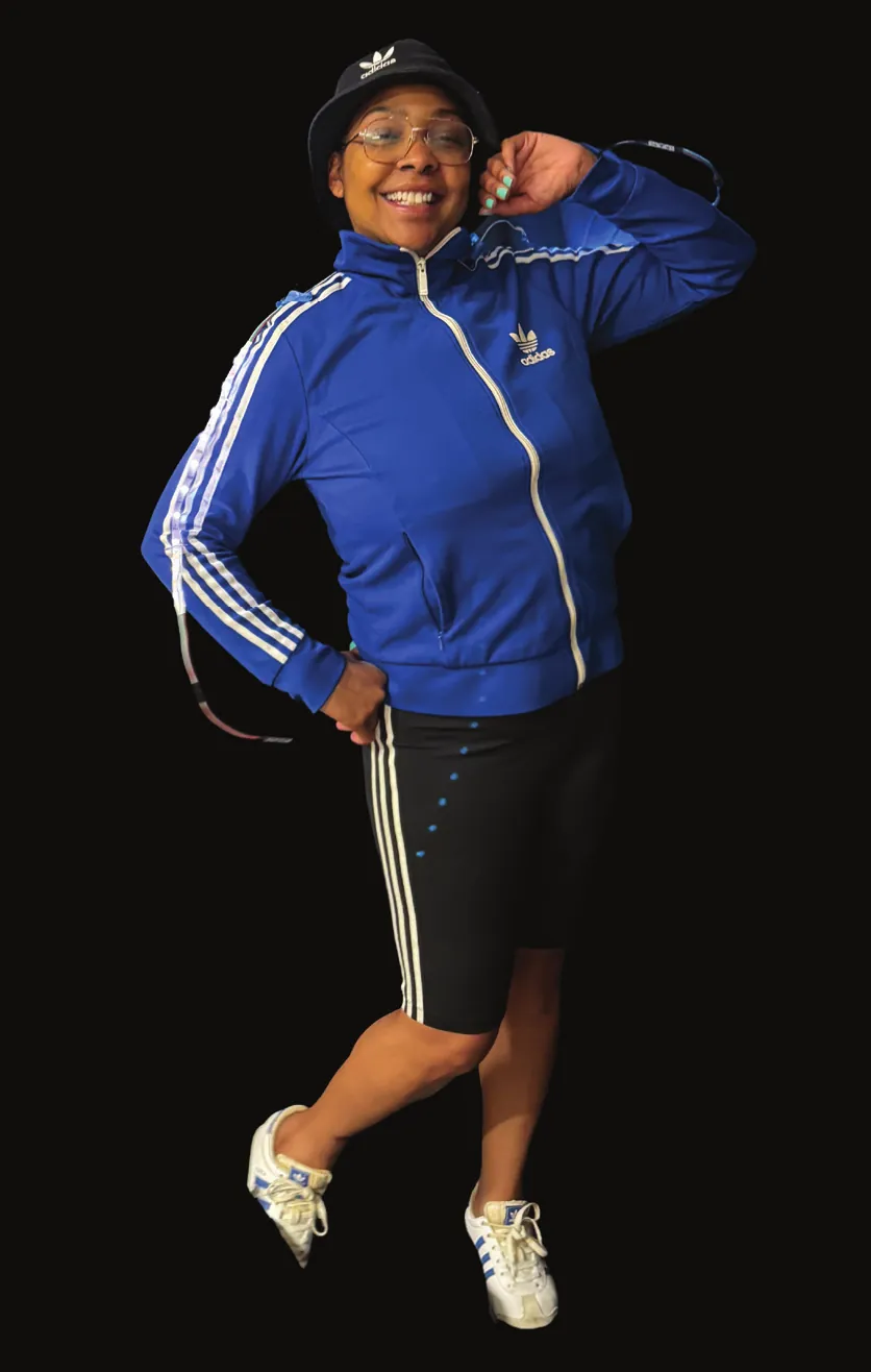 Hip Hop Culture: performer in a blue tracksuit jacket, bucket hat and sneakers, mid-jump