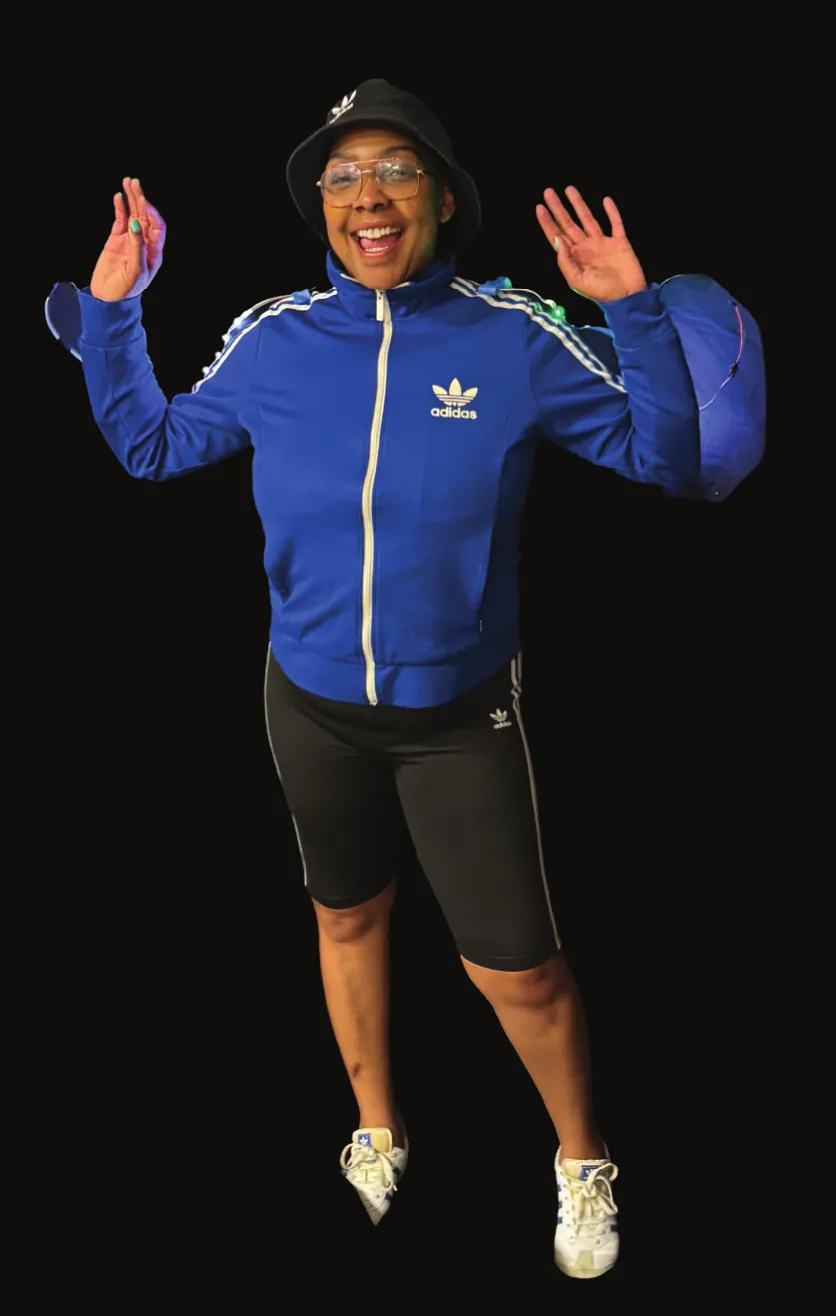 Hip Hop Culture: performer in a blue tracksuit jacket and bucket hat, hands raised and smiling