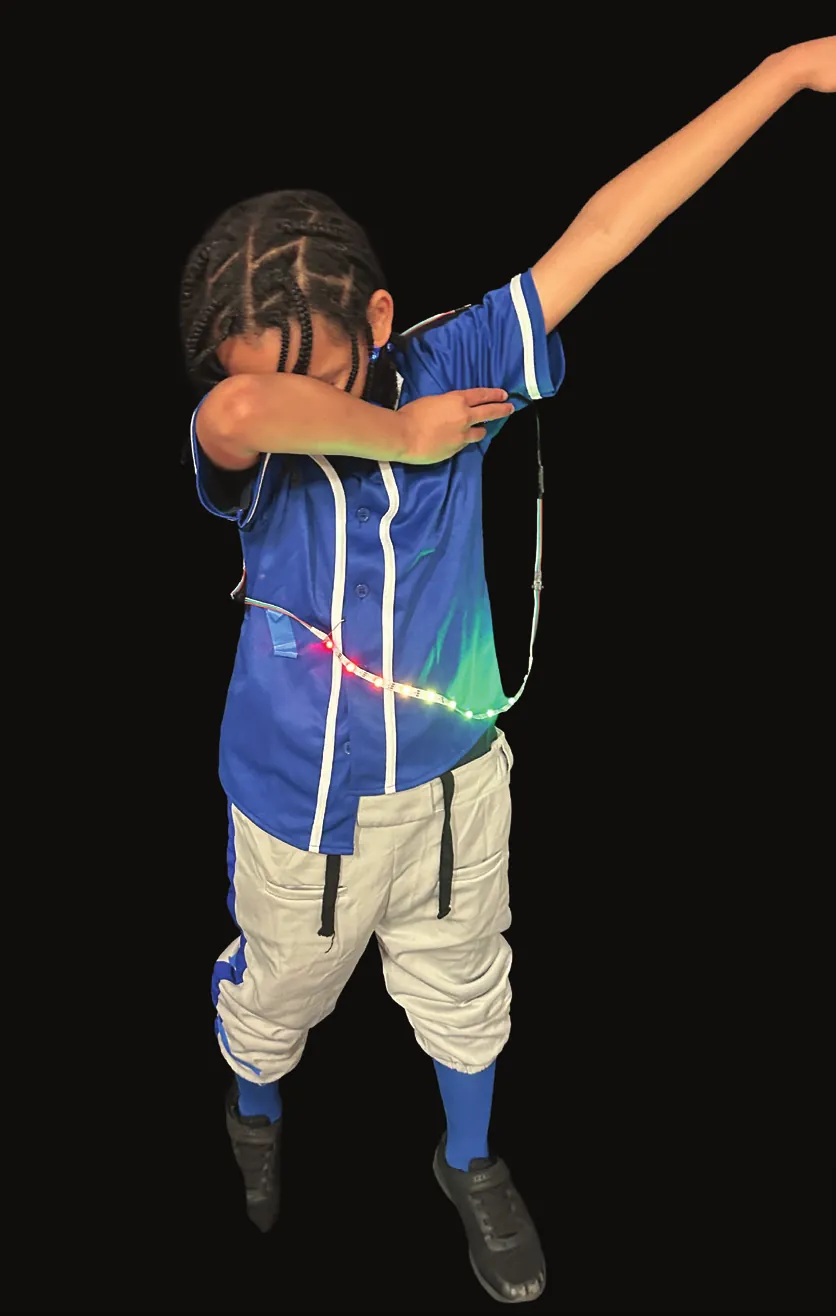 Student as Jackie Robinson striking a pose in a blue jersey and baseball pants trimmed with lights