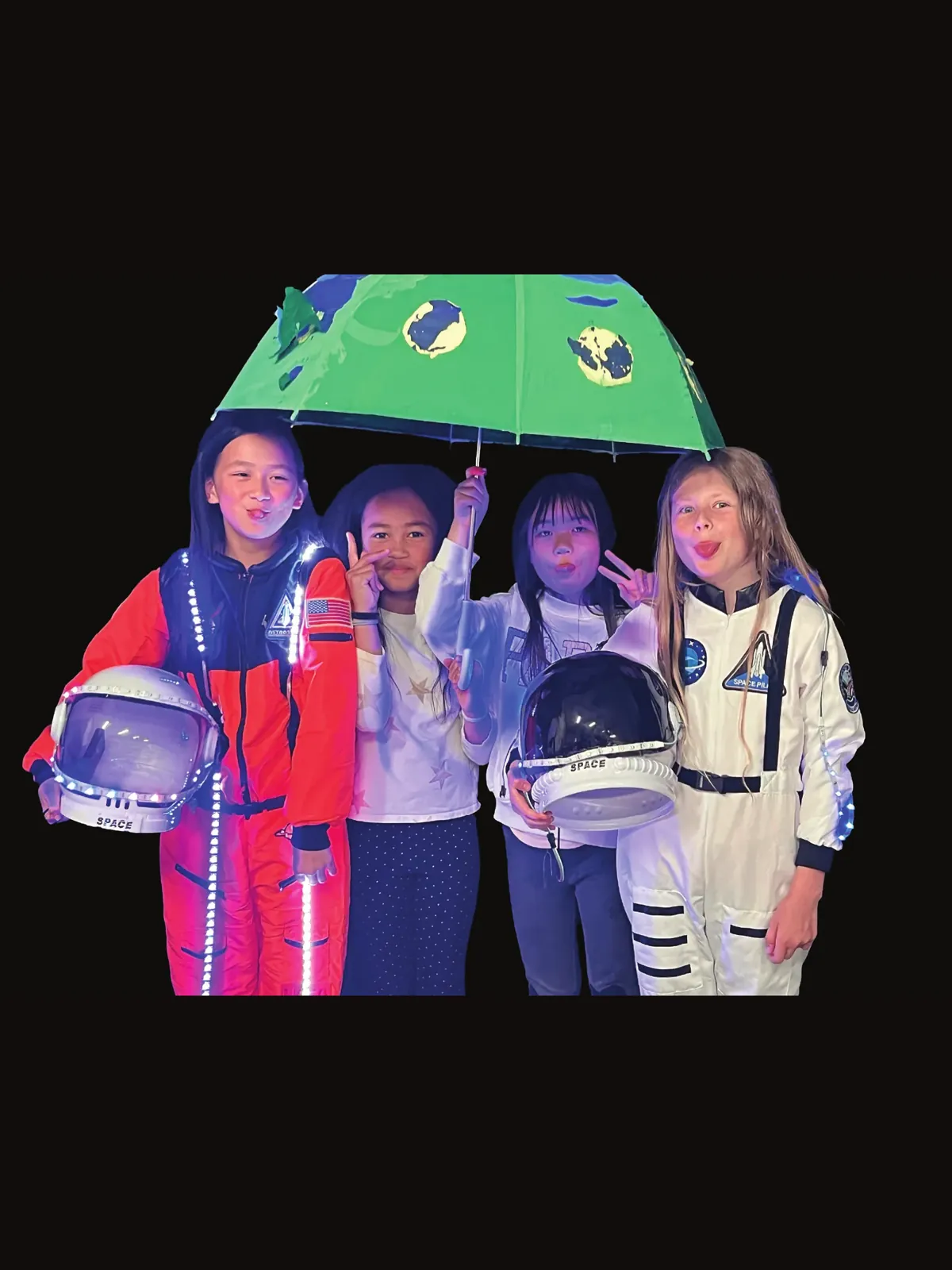 Four students in astronaut suits under a green umbrella printed with planets, for Stephanie Wilson