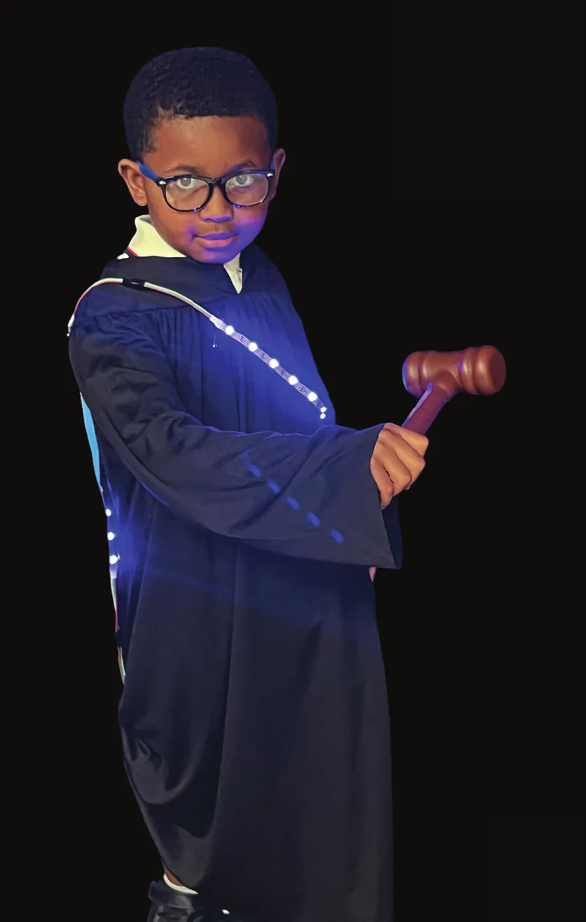 Student as Thurgood Marshall in a dark judge’s robe lined with blue LEDs, holding a gavel