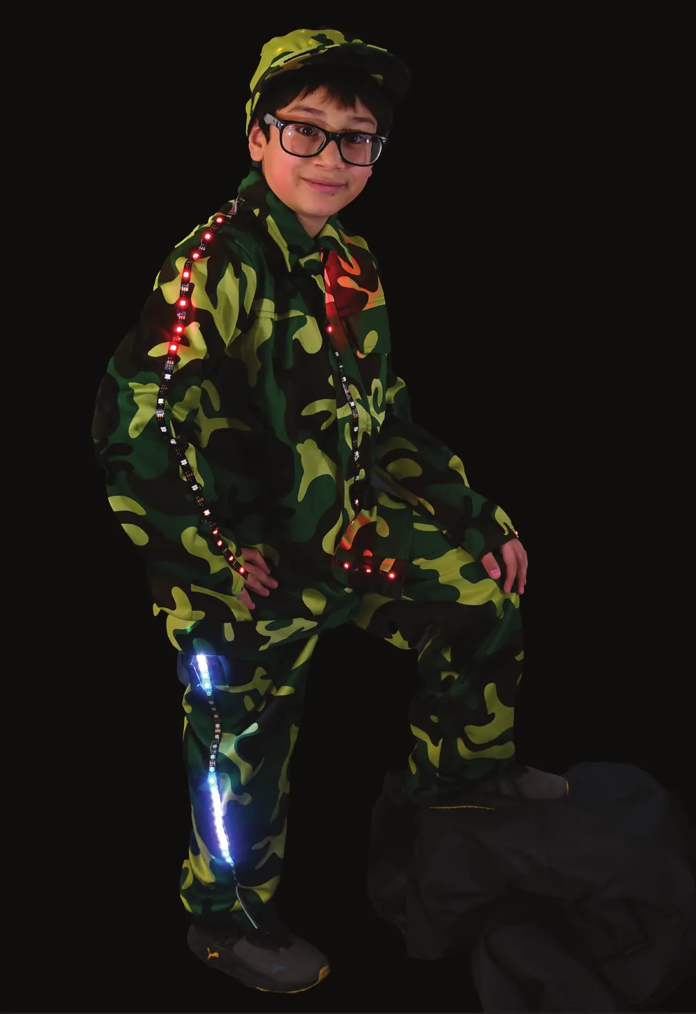 Guardians of the Neighborhood: student in a camouflage suit with lights running along the arms and legs