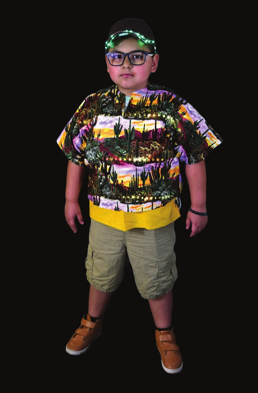 Sonoran Scene: student in a shirt printed with desert scenes and a lit headband