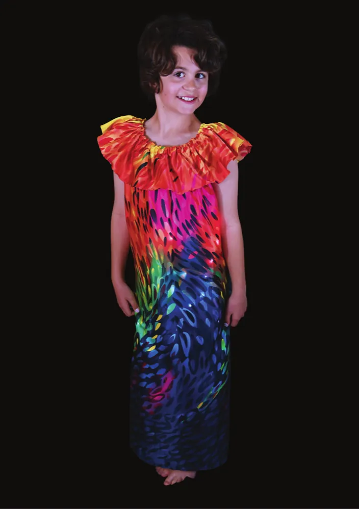 Warming Oceans: student in a long dress printed with bright red, orange and teal coral colors