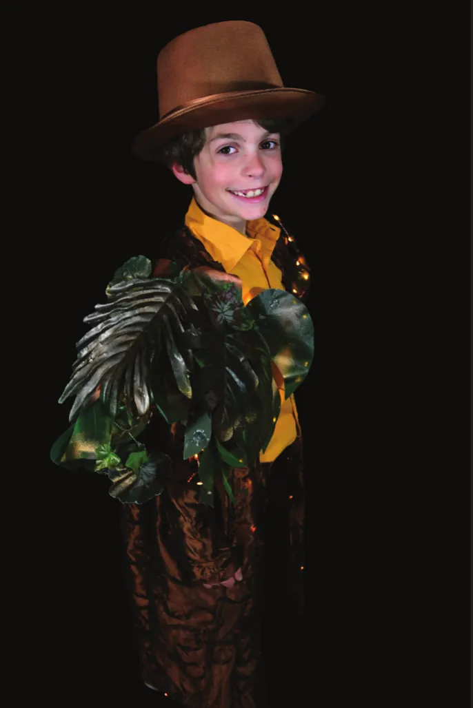 Decompose: student in a brown hat and a jacket covered in dark leaves