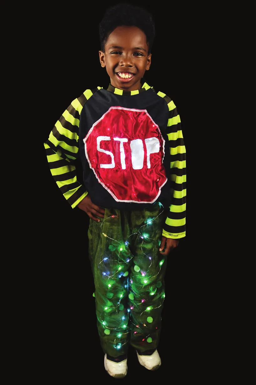 Disconnect: student in a top with a red STOP sign, yellow striped sleeves and pants glowing with green lights
